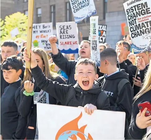  ?? ?? YOUNG VOICES: Pupils are expected to be out in force again on the streets of Scotland’s cities today – as they were during this climate strike in Dundee in 2019. Picture by Dougie Nicolson.