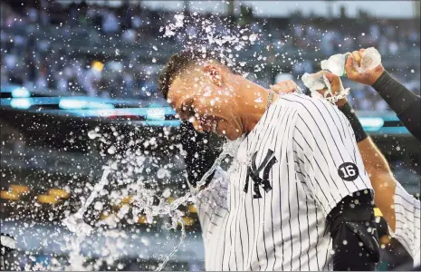  ?? Mike Stobe / Getty Images ?? The Yankees’ Aaron Judge celebrates after hitting a walk-off single in the bottom of the ninth inning to beat the Rays on Sunday and clinch a playoff berth.