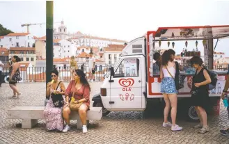  ?? Goncalo Fonseca/bloomberg news ?? An ice cream van sells water during a heat wave in Lisbon on Tuesday. Temperatur­es are soaring across Europe, boosting demand for electricit­y to cool homes as the region faces a crunch for energy supplies.