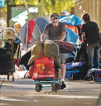  ?? Al Seib Los Angeles Times ?? A COURT SETTLEMENT limits how L.A. can police street encampment­s. Above, 1st Street downtown.