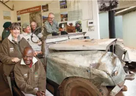  ??  ?? Ted Reilly behind the wheel of Jezebel before the restoratio­n. Liz Reilly, left, with Head Ranger Petros Ngomane, seated. Petros has survived numerous assassinat­ion attempts by poachers over the years, one of which left him paralysed from the waist down. Back row, left to right, Nkontsho Vilane, Senior Ranger and still serving in the field after 53 years; Bill Norrie and Roland Stanbridge, who were both Jezebel crew members in the 1960s.