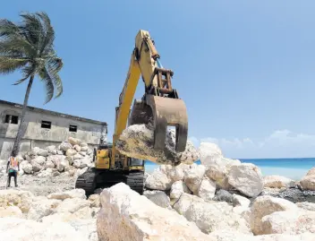  ?? IAN ALLEN/PHOTOGRAPH­ER ?? The seawall under constructi­on in Buff Bay, Portland, has been hailed as crucial to the preservati­on of the structural integrity of properties along the coastline.