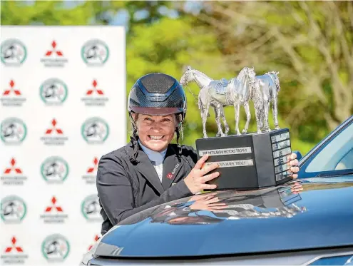  ?? PHOTOSPORT ?? New Zealand rider Jonelle Price shows off the winner’s trophy from the Badminton Horse Trials.