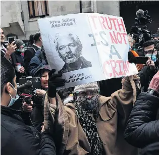  ?? PHOTO: GETTY IMAGES ?? Supporters of Julian Assange celebrate after the verdict outside the Old Bailey in London on Monday. District judge Vanessa Baraitser has denied the extraditio­n of Assange to the United States, citing ‘‘suicide risk’’.