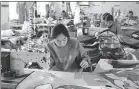  ?? PHOTOS BY WANG ZHI / XINHUA ?? Right: Workers at a local kite-making factory produce kites to meet orders.