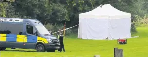  ??  ?? Police at the spot in Accrington Cemetery where Lindsay’s body was found