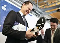  ?? THE CANADIAN PRESS ?? Finance Minister Eric Girard displays the new Quebec-made running shoes he plans to wear for his budget speech Thursday.