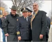  ?? NICHOLAS BUONANNO — NBUONANNO@TROYRECORD.COM ?? Members of the Rensselaer County Sheriff’s Office stand with North Greenbush Police Chief Robert Durivage after his retirement walk-out ceremony Friday. From left are Capt. Derek Pyle, Durivage and Rensselaer County Sheriff Pat Russo.