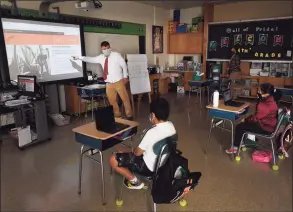  ?? Brian A. Pounds / Hearst Connecticu­t Media file photo ?? Music teacher Darren Stec speaks to students at Stillmeado­w Elementary School in Stamford on Oct. 8, 2020.