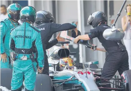  ?? Picture / AP ?? Lewis Hamilton pits for a replacemen­t headrest at the Azerbaijan Grand Prix, a move that cost him the race.