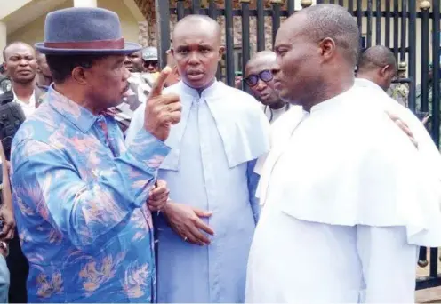  ?? PHOTO: Emma Elekwa ?? Governor Obiano being briefed by the priest of the church where worshipper­s were killed in Anambra yesterday.