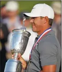  ?? BRIAN CIANCIO/TRIBUNE NEWS SERVICE ?? Brooks Koepka poses with the U.S. Open trophy after winning the tournament on June 17, 2018, at Shinnecock Hills Country Club in Southampto­n, N.Y.