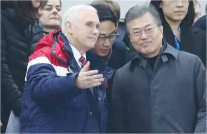  ?? (Damir Sagolj/Reuters) ?? US VICE PRESIDENT Mike Pence and South Korea’s President Moon Jae-in attend a short track speed skating event in Gangneung yesterday, during the first day of the Olympics.