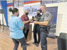  ?? [CARLA HINTON/ THE OKLAHOMAN] ?? Maria Milagro talks with Oklahoma City Police Chief Wade Gourley after the “Faith & Blue Weekend” community forum Saturday at St. James the Greater Catholic Church, 4201 S McKinley.