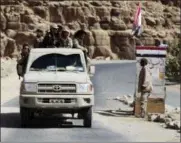  ?? JON GAMBRELL — THE ASSOCIATED PRESS ?? In this Friday photograph, Yemeni militiamen and soldiers allied to the country’s internatio­nally recognized government pass through a mountain checkpoint in the outskirts of Sanaa, Yemen. Yemen’s conflict, which began as a civil war in 2014 and...