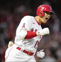  ?? ASHLEY LANDIS/AP 2021 ?? Angels designated hitter and starting pitcher Shohei Ohtani reacts as he rounds the bases after hitting one of his 46 home runs last season. Ohtani, who also was 9-2 with a 3.18 ERA, was named The Associated Press’ Male Athlete of the Year on Tuesday.