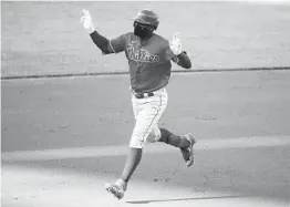  ?? ALEX BRANDON AP ?? Wearing a mask, Philadelph­ia’s Didi Gregorius celebrates after his three-run homer during the first inning off Washington’s Max Scherzer on Saturday.