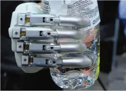  ??  ?? LAS VEGAS, Nevada: The “prosthetic hand” from BrainRobot­ics, controlled by signals sent from the residual muscles on an amputee’s limb, a process that involves some machine learning technology, holds a bottle for display.