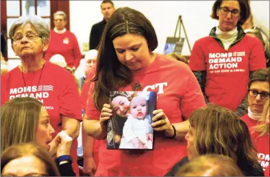  ?? Christian Abraham / Hearst Connecticu­t Media ?? Erin Bond, of Bethel, holds a photo of her neice Emily Todd, who was murdered in 2018 during a special state-wide event hosted by Moms Demand Action for Gun Sense in America at the Margaret Morton Government Center in downtown Bridgeport on Feb. 8. The event concluded a weeklong series of local events in recognitio­n of National Survivors Week, February 1 - 8. It also featured a Moments That Survive Story Wall, a display of photos and personal stories from Connecticu­t gun violence survivors that illustrate the effect gun violence has had on their lives.