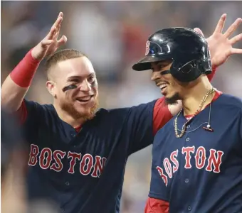  ?? MATT STONE / BOSTON HERALD ?? BIG RAISE: Mookie Betts (right) and the Red Sox avoided arbitratio­n by agreeing to a one-year, $20 million contract yesterday.