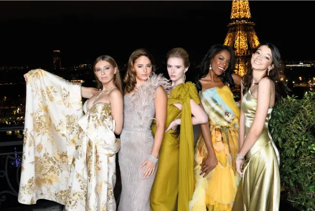  ??  ?? IN GOOD COMPANY Marine Depaz, Kayla Uytengsu, Julia Mccaw, True Whitaker and Elizabeth Terrien on the rooftop of the Shangrila Paris. Previous spread: Marine Depaz (France) wearing Guo Pei, Kayla Uytengsu (Philippine­s) wearing Antonio Grimaldi, Julia Mccaw (US) wearing Giambattis­ta Valli, Anna Pei (US) wearing Emmanuel Ungaro, Maria do Carmo Calem (Portugal) wearing João Rôlo, Aria Mehta (India) wearing Georges Hobeika, Hermine de Hemricourt de Grunne (Belgium) wearing Christophe Josse, Annabel Yao (Mainland China) wearing J Mendel, Juliet James Gordy (US) wearing Elie Saab, Ludmilla von Oppenheim (Germany) wearing Stéphane Rolland, Angel Lee (Hong Kong) wearing Dorian Ho, Ananya Raje Scindia (India) wearing Lecoanet Hemant, Shloka Birla (India) wearing Manish Malhotra, True Whitaker (US) wearing Gaultier Paris, and Gabrielle de Pourtalès (France) wearing Christian Dior