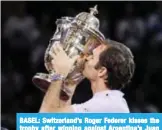  ?? AFP ?? BASEL: Switzerlan­d’s Roger Federer kisses the trophy after winning against Argentina’s Juan Martin del Potro in their final tennis match.—