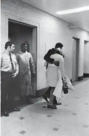  ?? OVIE CARTER/CHICAGO TRIBUNE ?? Alone in their grief, two people huddle together for comfort as they leave the Cook County Morgue after identifyin­g the body of a relative on Oct. 30, 1972.