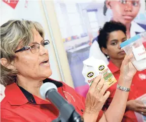  ?? RUDOLPH BROWN/PHOTOGRAPH­ER ?? Deborah Chen (left), executive director of Heart Foundation of Jamaica, explains the sugar content in drinks on the market, while Ponetta Nurse (right), advocacy officer of Heart Foundation of Jamaica, looks on during a press briefing to highlight the findings of an obesity prevention survey at Spanish Court Hotel in New Kingston yesterday.
