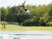  ?? ?? Instructor Nathan Simmons performs a trick at the Orlando Watersport­s Complex.