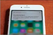  ?? PAUL SANCYA/AP PHOTO ?? The first test of the national wireless emergency system by the Federal Emergency Management Agency is shown on a cellular phone in Detroit on Wednesday. About 225 million electronic devices across the United States received alerts from FEMA Wednesday afternoon.