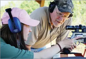  ?? KEITH SUTTON/CONTRIBUTI­NG PHOTOGRAPH­ER ?? Introducin­g children and adult newcomers to hunting, fishing or target shooting is an ideal way to celebrate National Hunting and Fishing Day on Saturday. Here, Bill Booth with Smith & Wesson assists a student at a local shooting range.