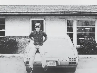  ?? Photo by John Moore, circa 1980 ?? ■ A high school friend of John Moore sits atop John’s 1972 Oldsmobile Cutlass Supreme.