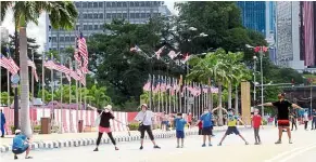  ??  ?? No parade, no problem: Although there was no parade, many came to Dataran Merdeka to celebrate National Day. — ART CHEN/ The Star