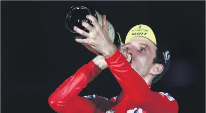  ?? Picture: AFP ?? SWEET WIN. Simon Yates celebrates on the podium after winning the Tour of Spain on Sunday.