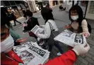  ?? ?? People in Tokyo receive extra editions of a newspaper reporting Japan’s Shohei Ohtani wnning the AL’s Most Valuable Player on Friday. Photograph: Issei Kato/