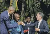  ?? Andrew Harnik Pool Photo ?? SECRETARY of State Antony J. Blinken greets former NBA star and Congo native Dikembe Mutombo.