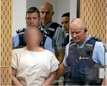  ?? GETTY IMAGES ?? The man charged in relation to the Christchur­ch massacre, Brenton Tarrant, is led into the dock for his appearance for murder in the Christchur­ch District Court last Saturday.