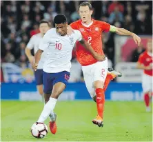  ?? RUI VIEIRA, THE ASSOCIATED PRESS ?? England’s Marcus Rashford, left, and Switzerlan­d’s Stephan Lichtstein­er battle for the ball during their internatio­nal friendly in Leicester on Tuesday.