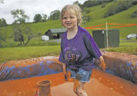  ?? PHOTOS BY LUKE CHRISTOPHE­R FOR FOOTHILLS FORUM ?? Theresa Doyle enjoys the mud pit.