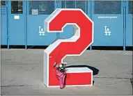  ?? MARCIO JOSE SANCHEZ / AP ?? Flowers are placed in front of Tommy Lasorda’s retired No. 2 at Dodger Stadium Friday in Los Angeles.