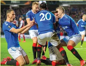  ?? ?? Rangers players mob Hagi after his second goal in Thursday’s 3-2 win UNITED: