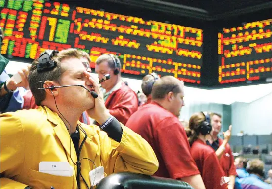  ??  ?? In this Sept 16, 2008, file photo clerk Michael Hill puts his hand on his face in the Euro Dollar options trading pit after the Fed Interest Rate announceme­nt at the CME Group in Chicago. Home prices had sunk, and foreclosur­e notices began arriving. Layoffs began to spike. Tremors intensifie­d as Lehman Brothers, a titan of Wall Street, slid into bankruptcy on Sept 15, 2008. Stockmarke­ts shuddered and then collapsed in a cascading panic that government officials struggled to stop. (AP)