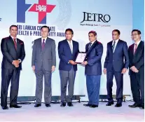 ??  ?? Corporate Affairs Director Johann Rodrigo and HR and Corporate Sustainabi­lity Deputy General Manager Anuruddha Gamage accepting the award from Minister Dr. Harsha de Silva, the ambassador of Japan to Sri Lanka, and Senior Officials from JETRO and COYLE