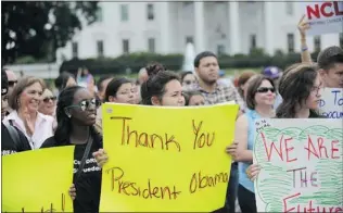  ?? OLIVIER DOULIERY/ ABACA PRESS ?? Supporters of President Barack Obama’s decision to grant partial amnesty to young law- abiding illegal immigrants who came to the U. S. as children gather outside the White House on Friday.