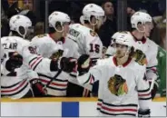  ?? MARK ZALESKI — THE ASSOCIATED PRESS FILE ?? In this file photo, Chicago Blackhawks left wing Vinnie Hinostroza (48) is congratula­ted after scoring a goal against the Nashville Predators during the second period of an NHL hockey game, in Nashville, Tenn.