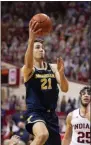  ?? DOUG MCSCHOOLER - THE ASSOCIATED PRESS ?? Michigan guard Franz Wagner (21) drives to the basket during the first half of an NCAA college basketball game against Indiana, Saturday, Feb. 27, 2021, in Bloomingto­n, Ind.