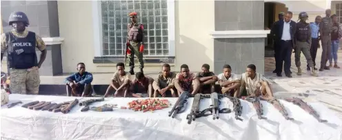  ?? Photo: Itodo Daniel Sule ?? Suspected kidnappers/armed robbers with some exhibits recovered, during their paraded by the Kogi State Police Command in Lokoja on Monday. Amongst the suspects are two serving policemen and navy personnel
