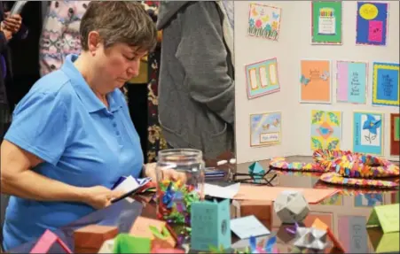  ?? MARIAN DENNIS — DIGITAL FIRST MEDIA ?? One of the activities featured at the open house for the TriCounty Active Adult Center Saturday was origami. The new center on Moser Road will feature over 90 different activities for older adults to enjoy.