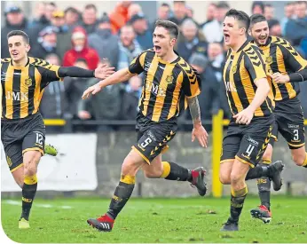  ??  ?? The Talbot players celebrate after Craig Mccracken, centre, opens the scoring