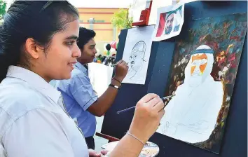  ?? Clint Egbert/Gulf News ?? Students paint portraits of Mahatma Gandhi and Shaikh Zayed at the Indian High School. Gandhi’s birthday on October 2 is also celebrated as Internatio­nal Day of Non-Violence.